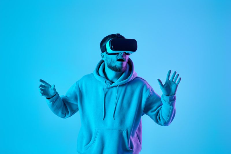 man using virtual reality glasses and playing video games